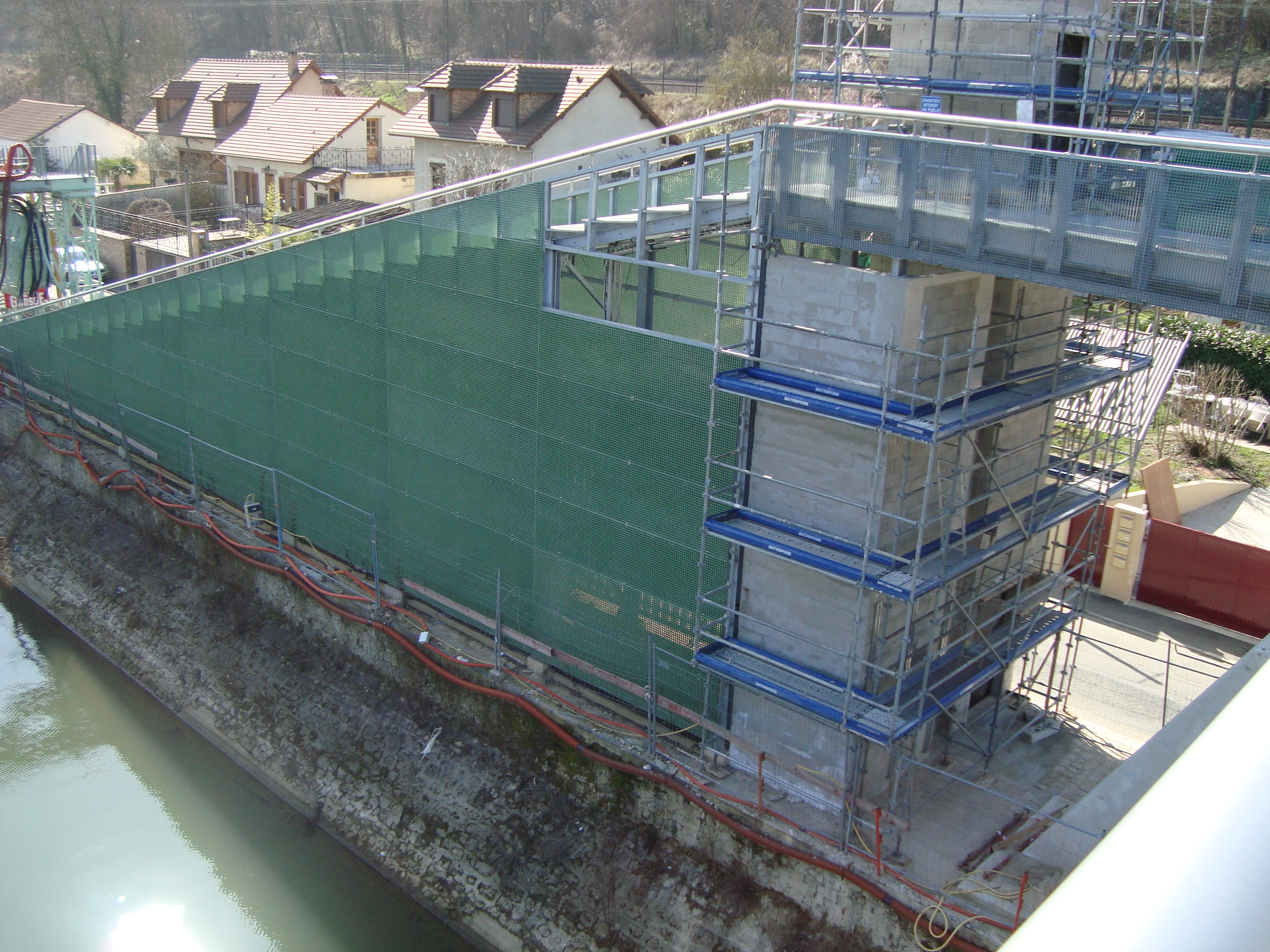 Access ramp and bridge pier clad in green FRP grating