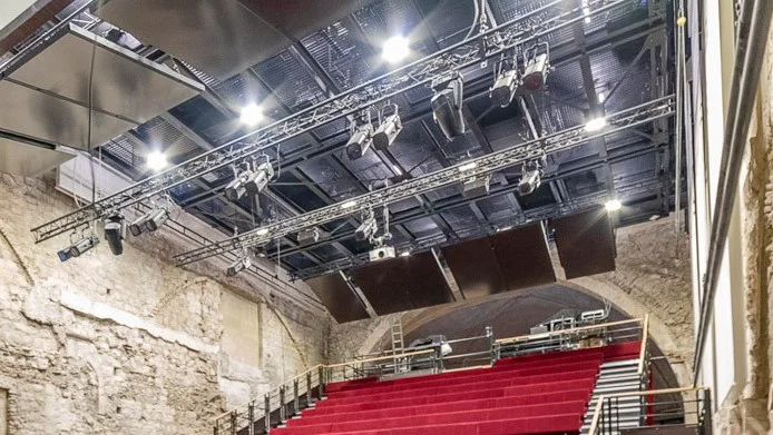 Stage grating conceals spotlights while allowing their beams of light to pass through