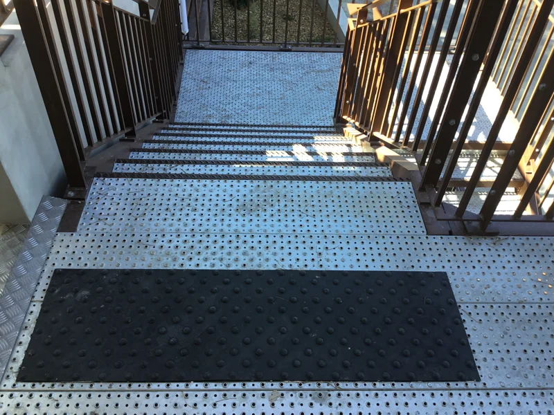 Tactile paving slab installed on a landing